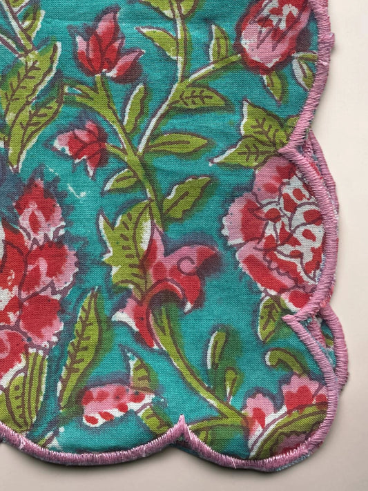 Reusable blue floral cotton napkin with decorative pink edging for elegant tab