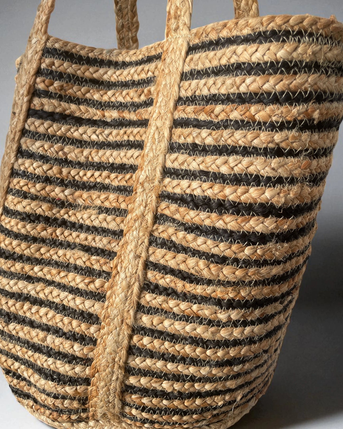 close up detail of braided black and natural striped bag