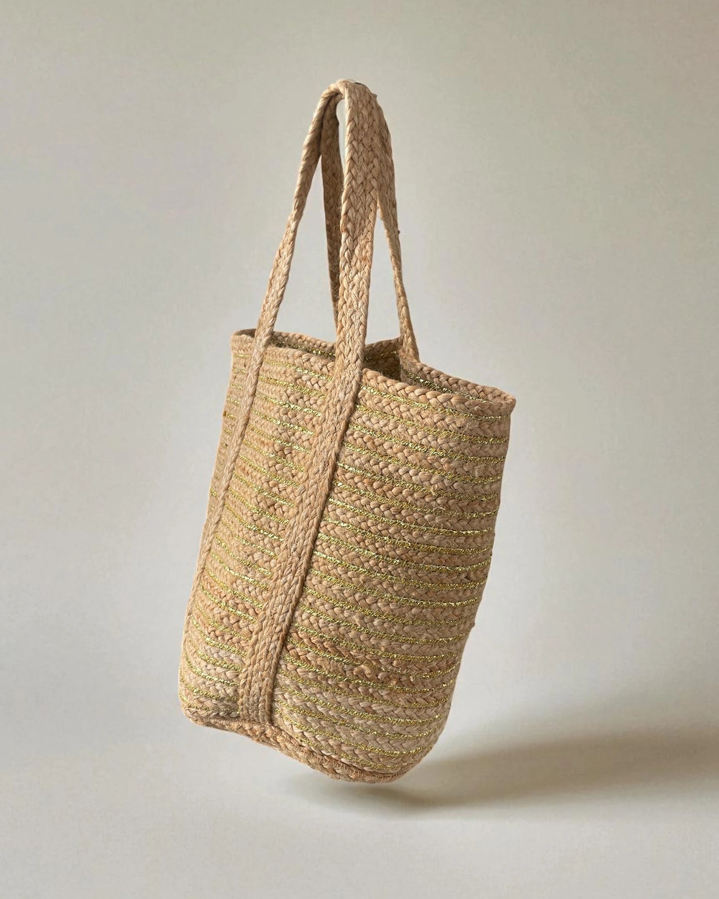 Woven eco friendly jute tote bag on a light gray background