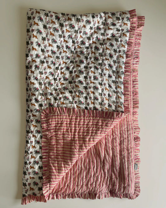 Artisan-crafted cotton quilt decorated with intricate block prints of jungle animals and flowers, offering a lightweight yet cozy cotton filling.