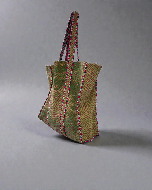 Handcrafted geometric tote bag with green and natural stitched diamond pattern