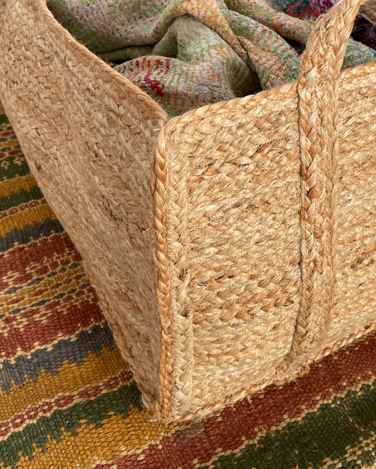 close up of hand braided natural foldable log basket