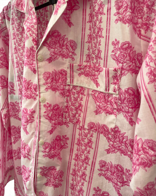Close-up of pink floral cotton pyjama shirt with button front and striped border trim