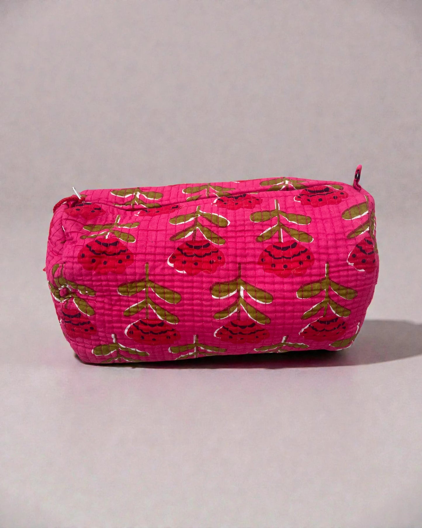 three-piece pink quilted toiletry bag set featuring floral pattern and beaded tassel zips