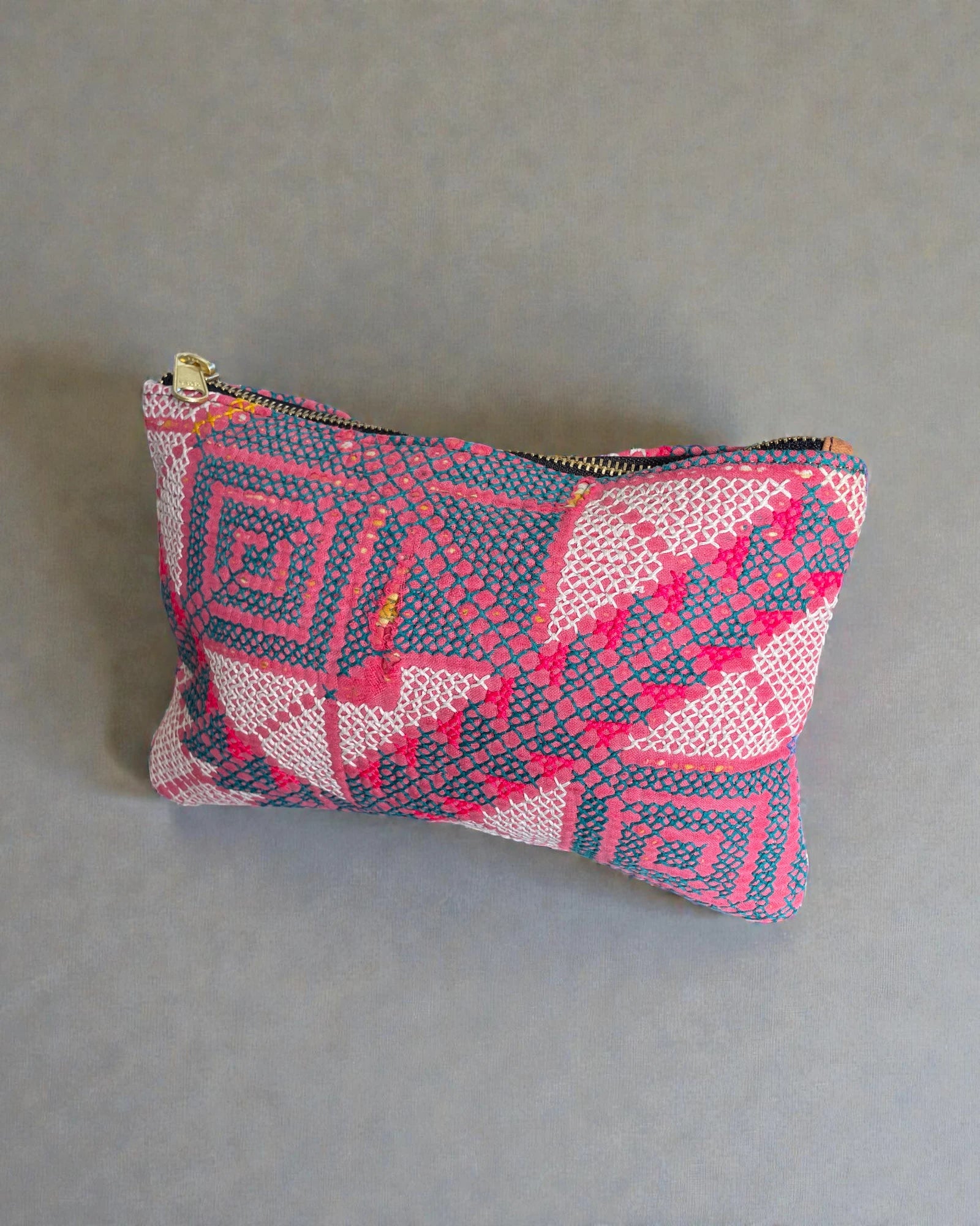Pink and teal patterned makeup bag made from textured woven fabric