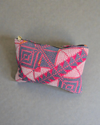 Pink and teal patterned makeup bag made from textured woven fabric