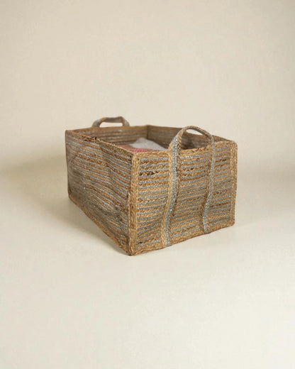 Woven extra large storage basket with handles on a beige background