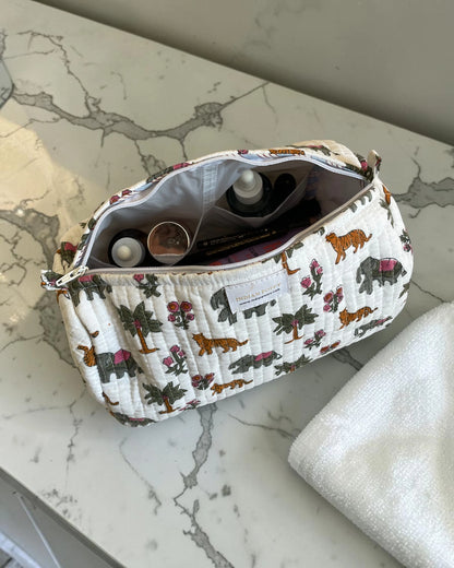 Animal print cosmetics wash bag in a luxury bathroom, stylish toiletry pouch for makeup and travel essentials displayed on an elegant vanity showing use for cosmetics