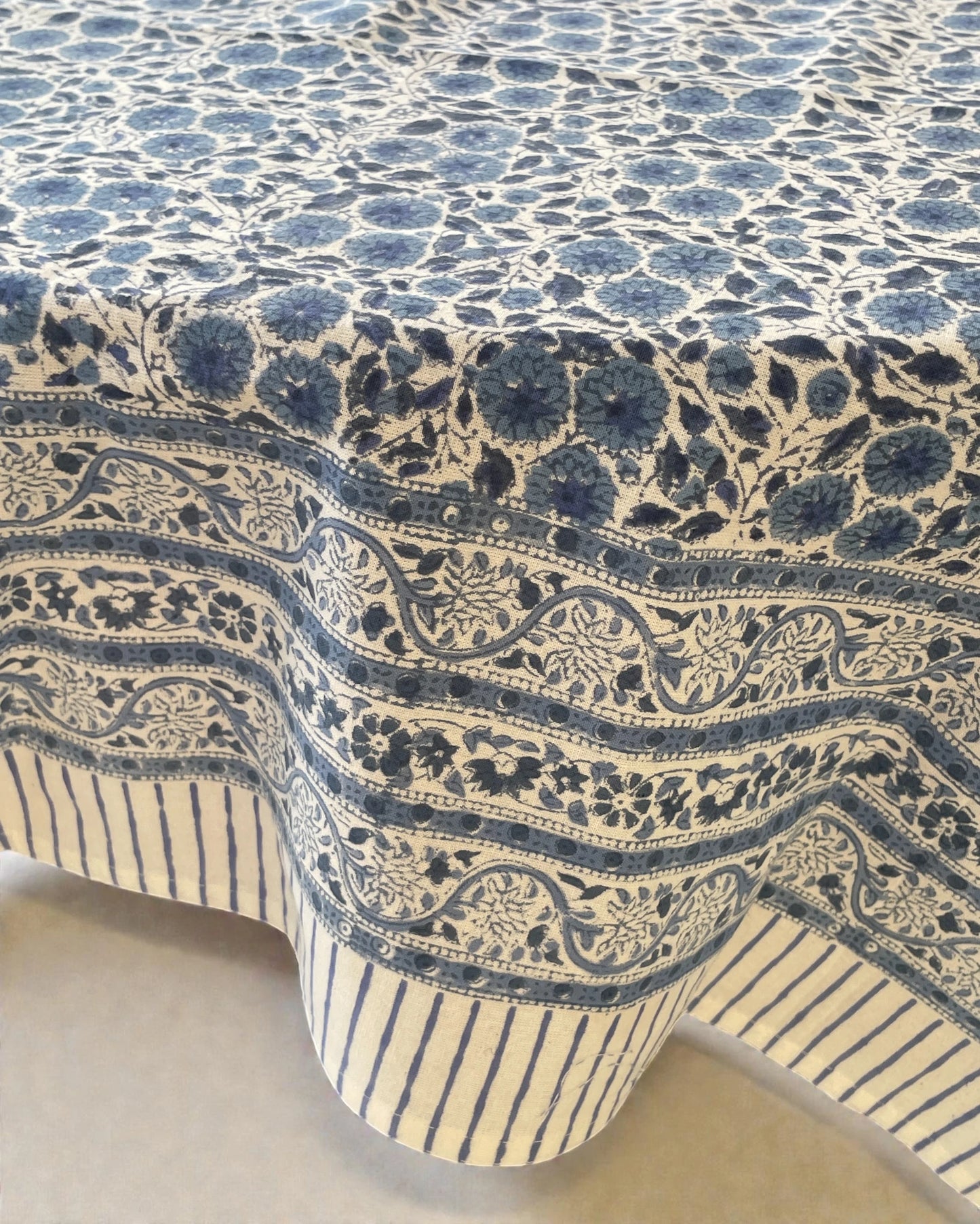 blue floral block print tablecloth with intricate botanical pattern and striped border