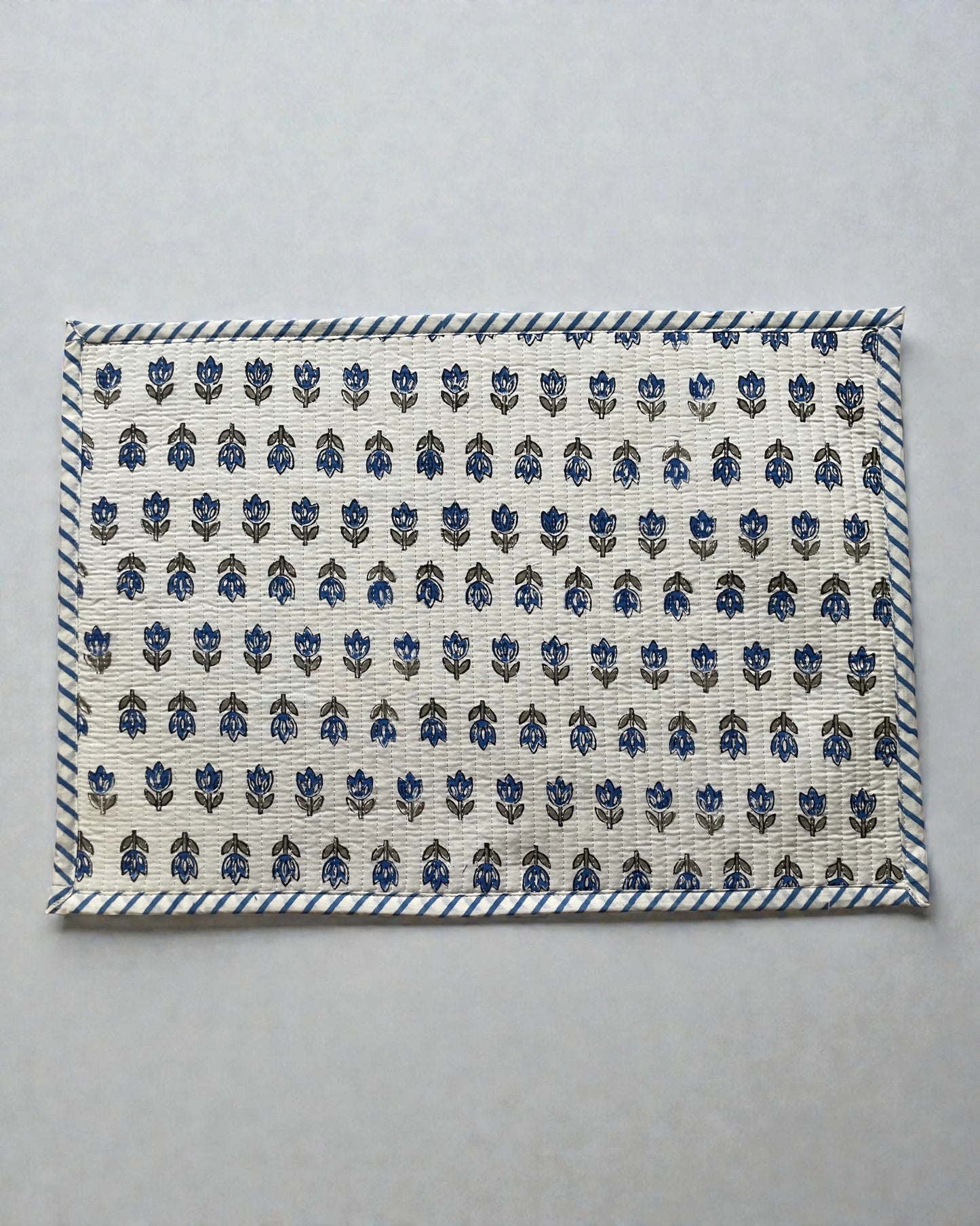 blue floral butti quilted cotton placemats with a striped blue and white border 