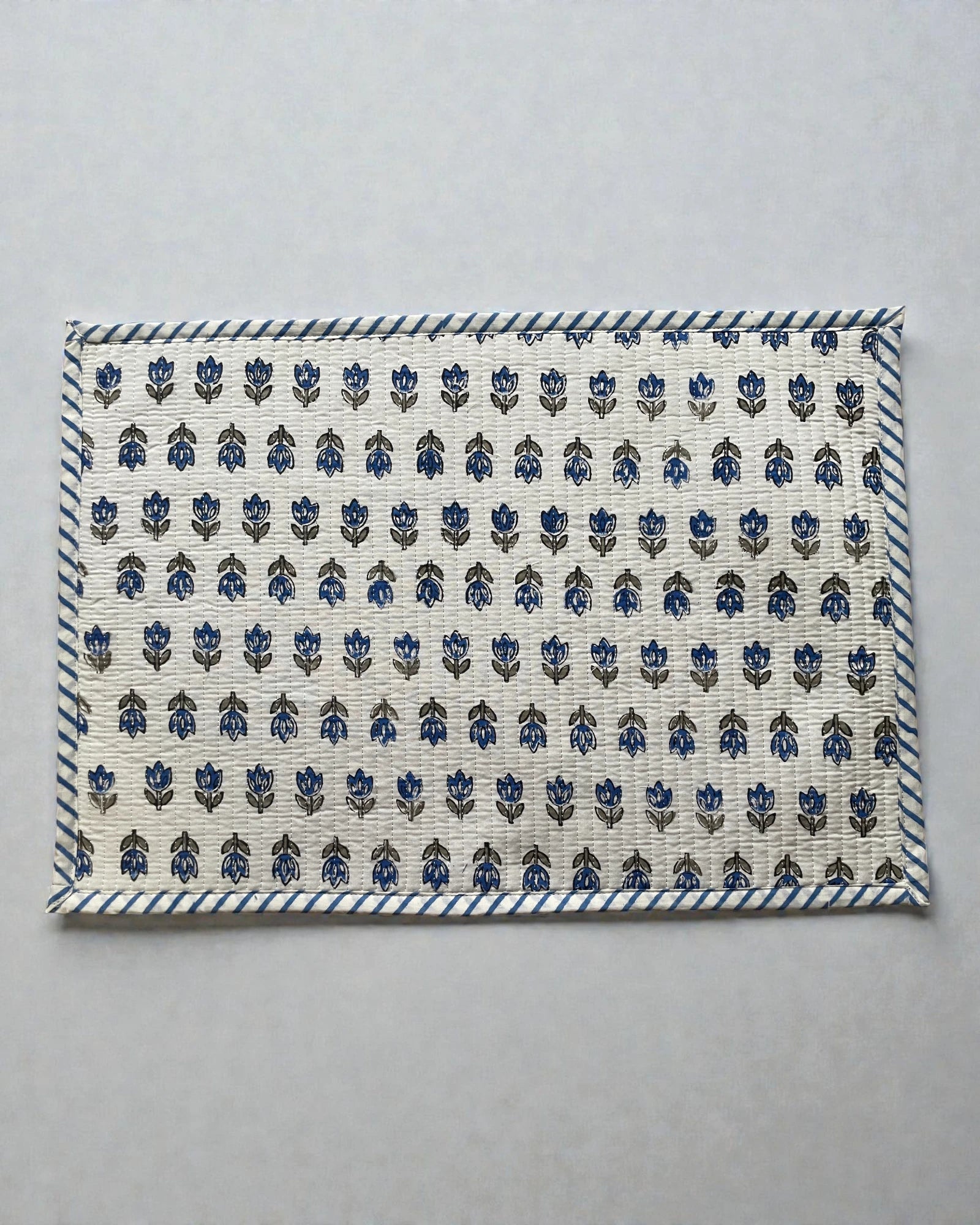 blue floral butti quilted cotton placemats with a striped blue and white border 