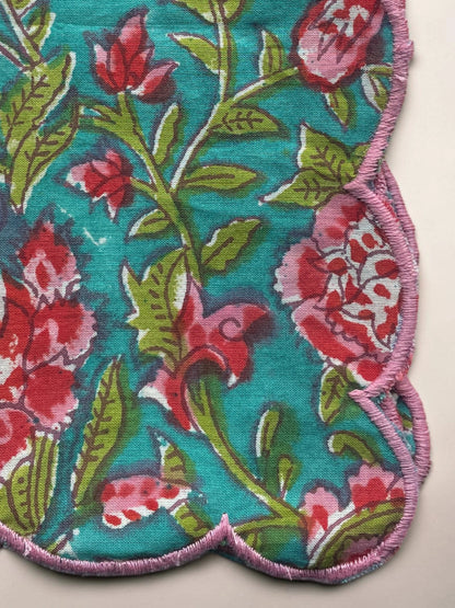 Reusable blue floral cotton napkin with decorative pink edging for elegant tab