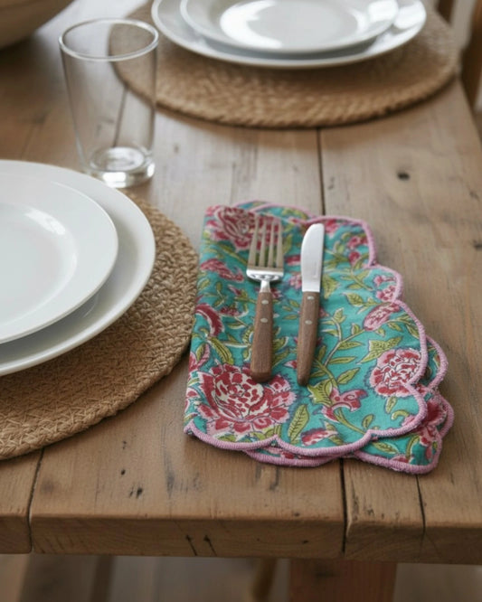 Blue floral block print cotton napkin with contrasting pink scalloped trim, perfect for elegant table settings