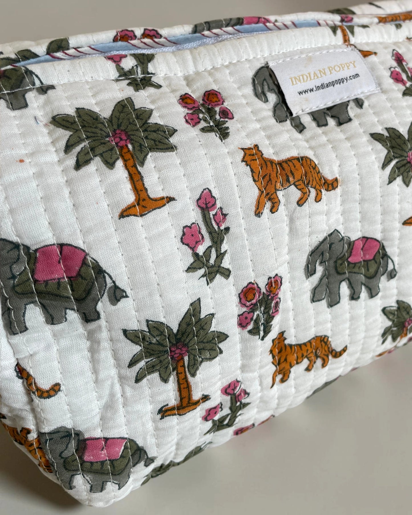 Close-up of a handmade block printed flora and fauna wash, toiletry and cosmetics bag, stylish fabric pouch with artisan design for beauty and travel essentials