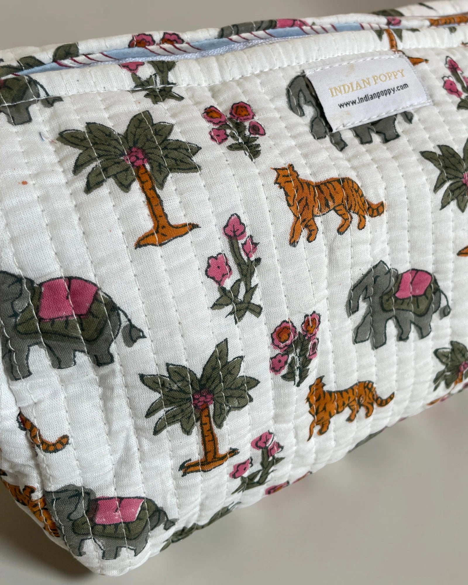 Close-up of a handmade block printed flora and fauna wash, toiletry and cosmetics bag, stylish fabric pouch with artisan design for beauty and travel essentials