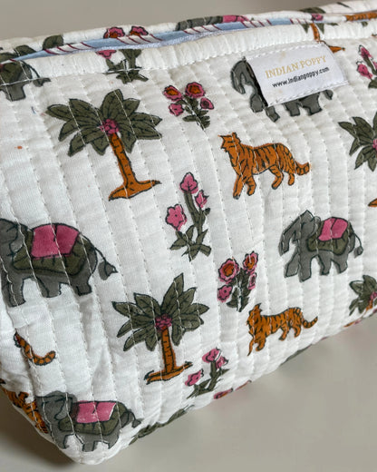 Close-up of a handmade block printed flora and fauna wash, toiletry and cosmetics bag, stylish fabric pouch with artisan design for beauty and travel essentials