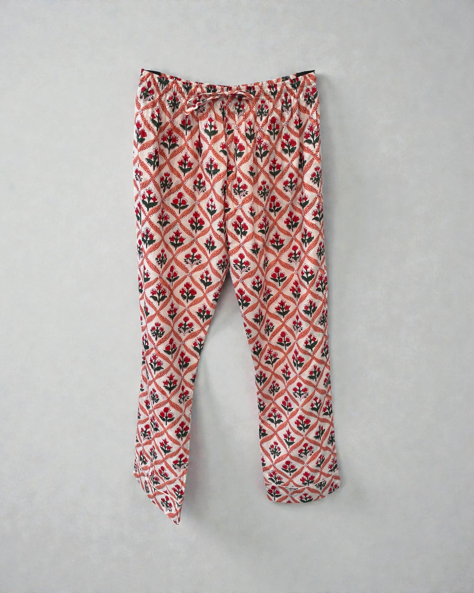 100% cotton floral pyjama trousers with pockets and drawstring elasticated waist in scarlet red and coral pink