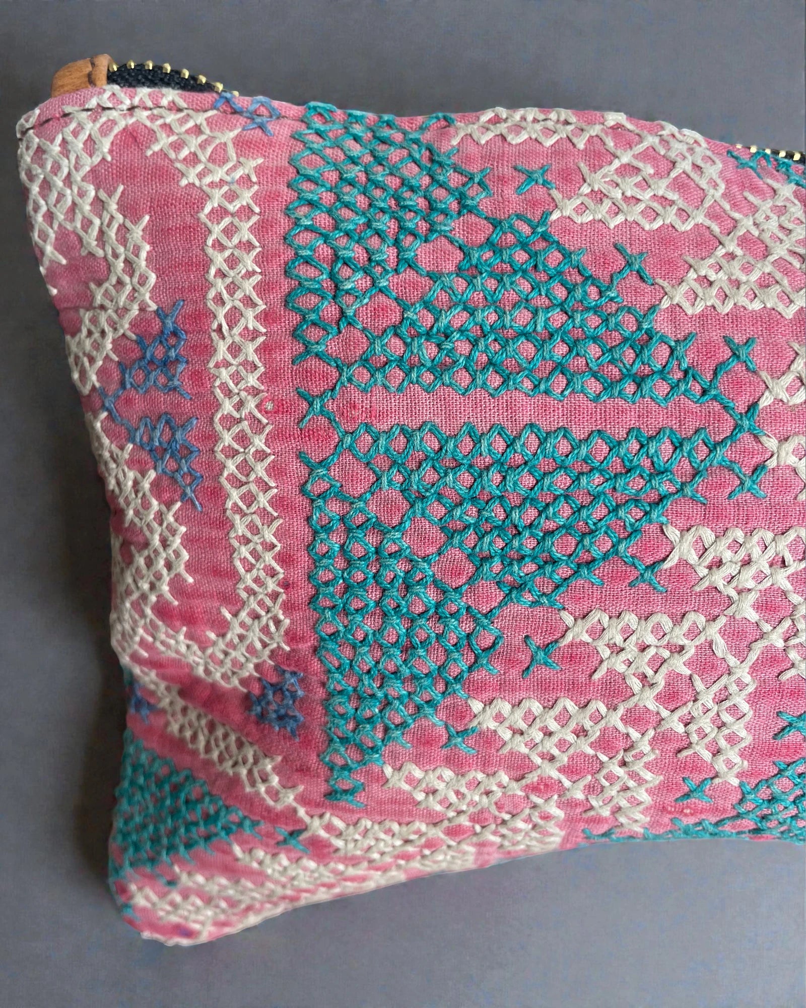 close up detailing of hand stitching on vintage textile perfect purse for cosmetics in the handbag or to keep passports and tickets safe while travelling