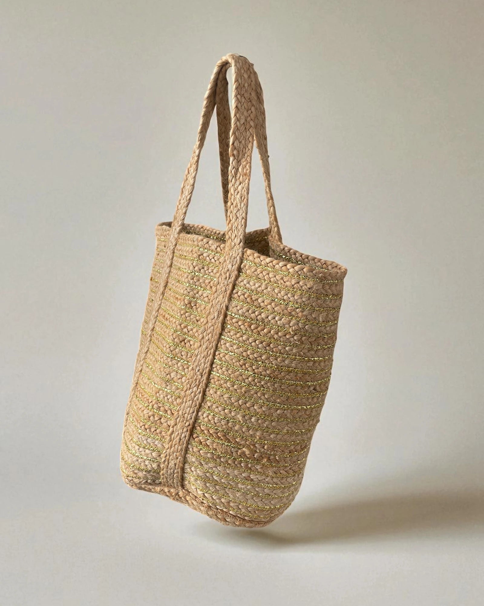 Woven eco friendly jute tote bag on a light gray background