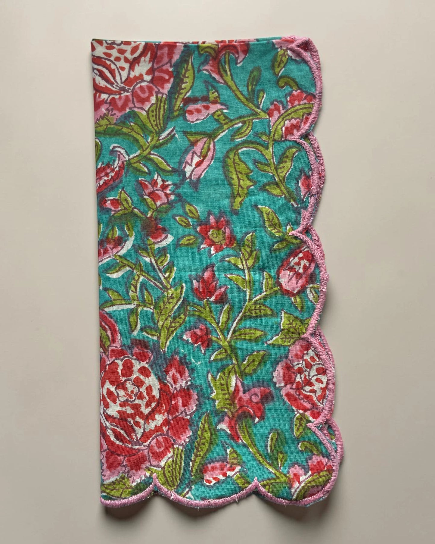 Cotton napkin featuring a blue floral block print design and contrasting pink