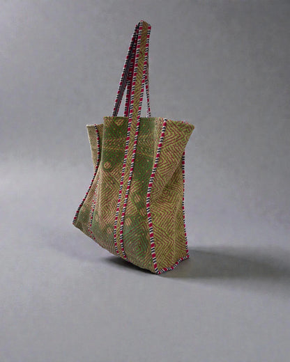 Handcrafted geometric tote bag with green and natural stitched diamond pattern