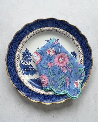 Pink floral cotton napkin set with scalloped edges and teal border, perfect for elegant table settings