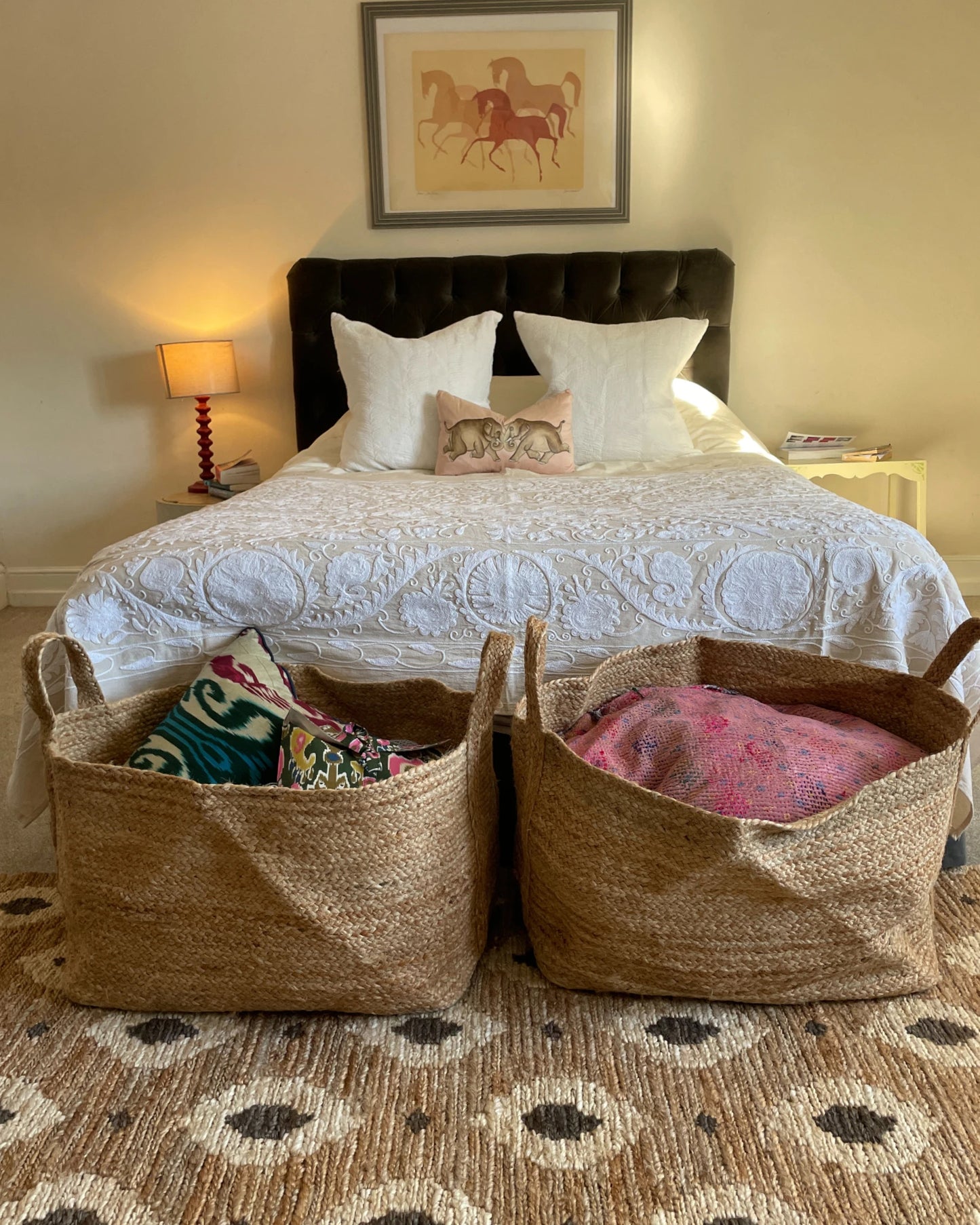 Natural jute runner rug placed at the end of a bed showing plaited flat weave texture