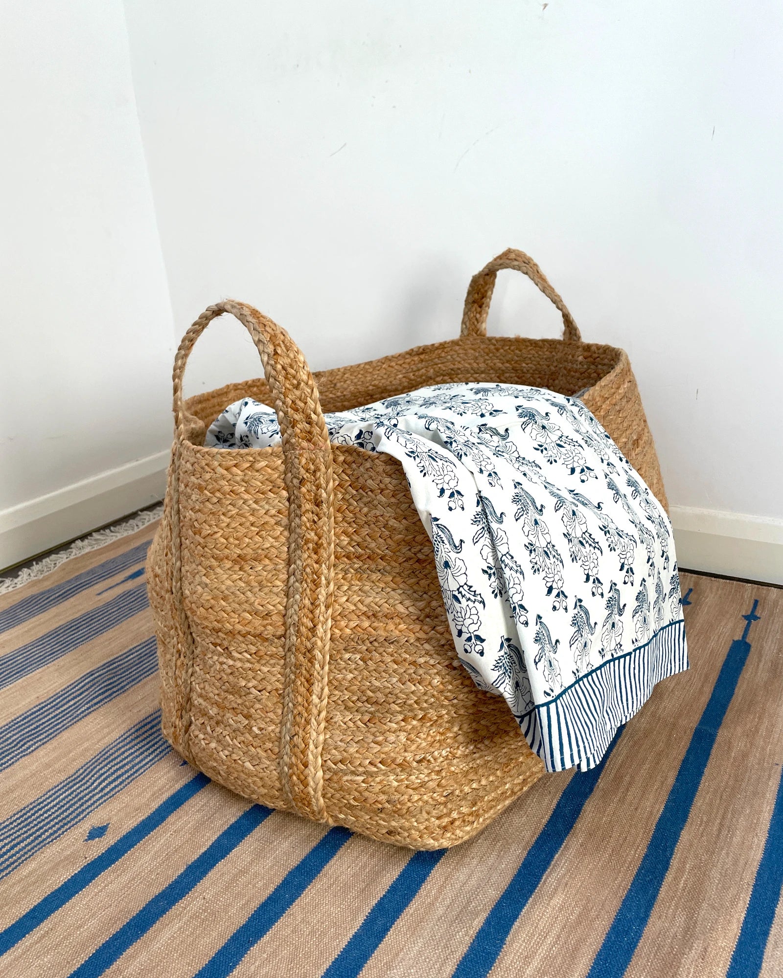 Woven blanket or laundry basket suitable for storing textiles and soft furnishings in the home
