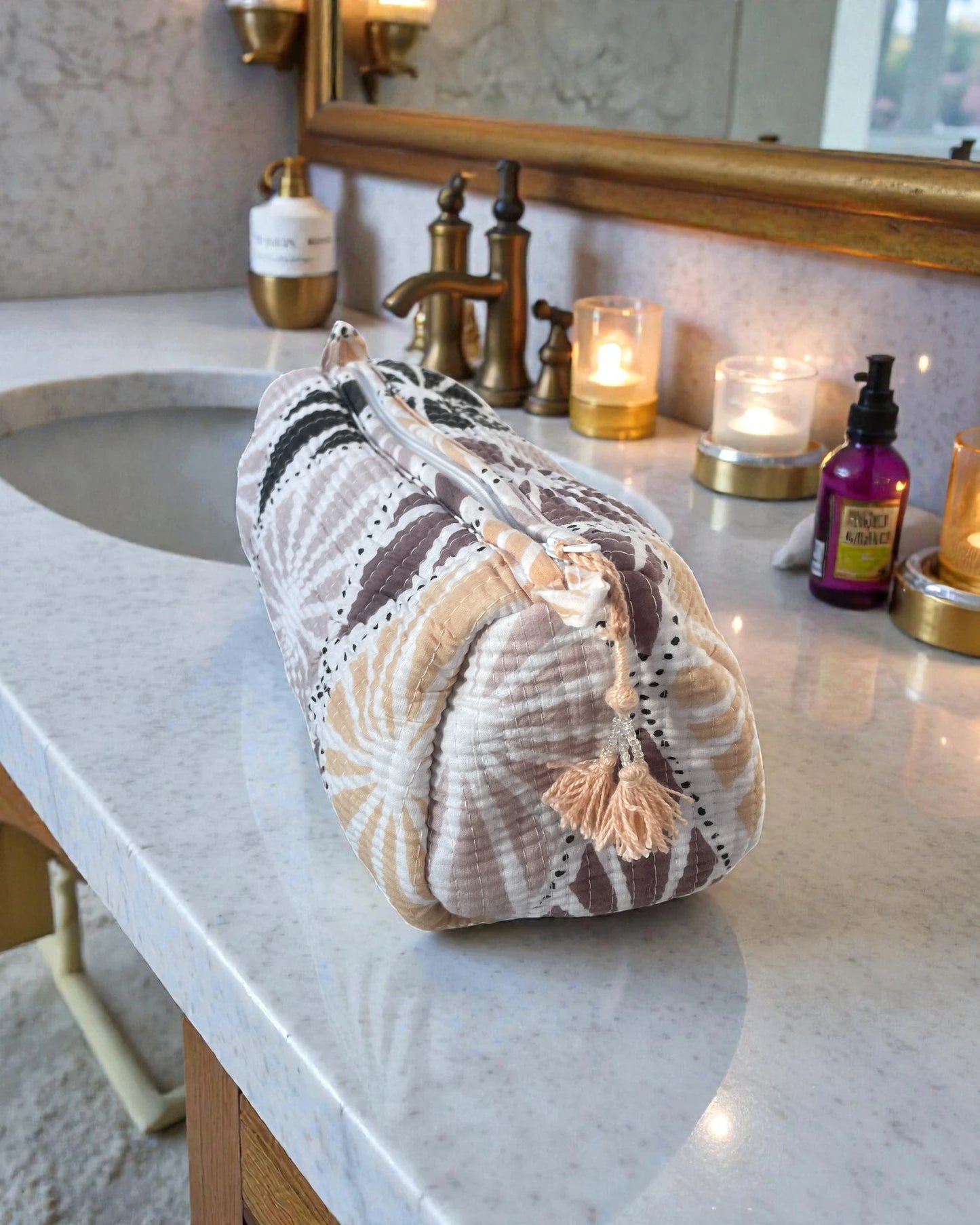 pastel quilted cosmetic bag with shell-inspired block print in soft pink, black and peach tones