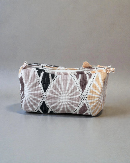 medium quilted cotton wash bag with pastel geometric shell motif on patterned tiles