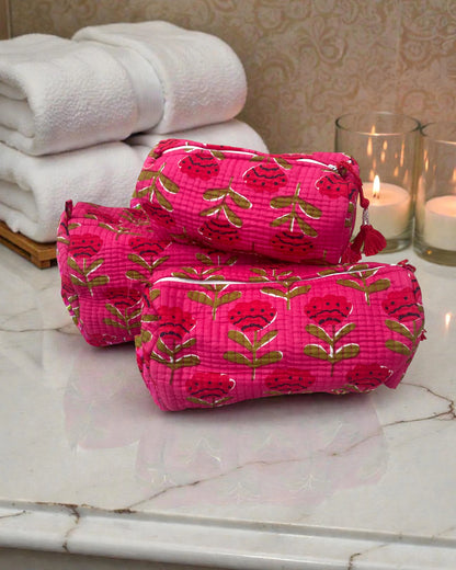 set of three cosmetic bags in small, medium and large with bright pink floral print and water-resistant lining