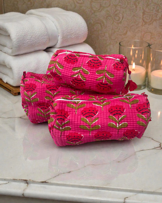 set of three cosmetic bags in small, medium and large with bright pink floral print and water-resistant lining