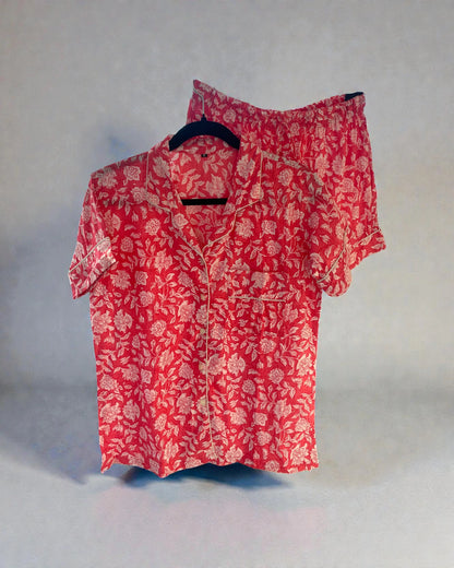 pink floral cotton pyjama set with short sleeve shirt and shorts hanging on hanger
