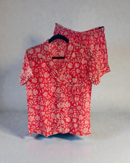 pink floral cotton pyjama set with short sleeve shirt and shorts hanging on hanger