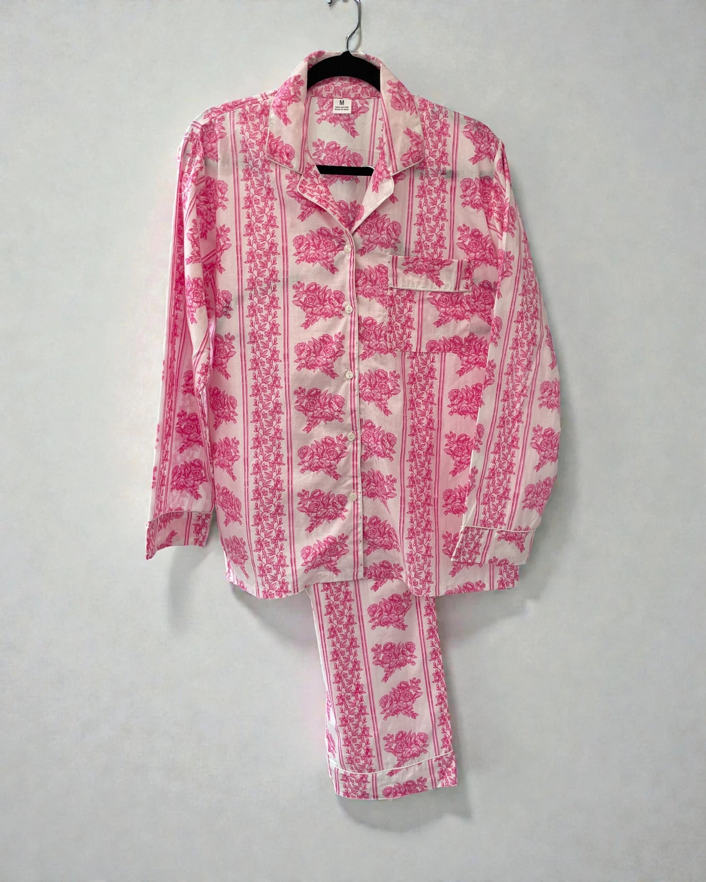 Pink floral cotton pyjama set with striped border, long sleeve button shirt and matching trousers
