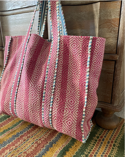 Pink quilted cotton tote bag with striped fabric handles and contrasting trim detail