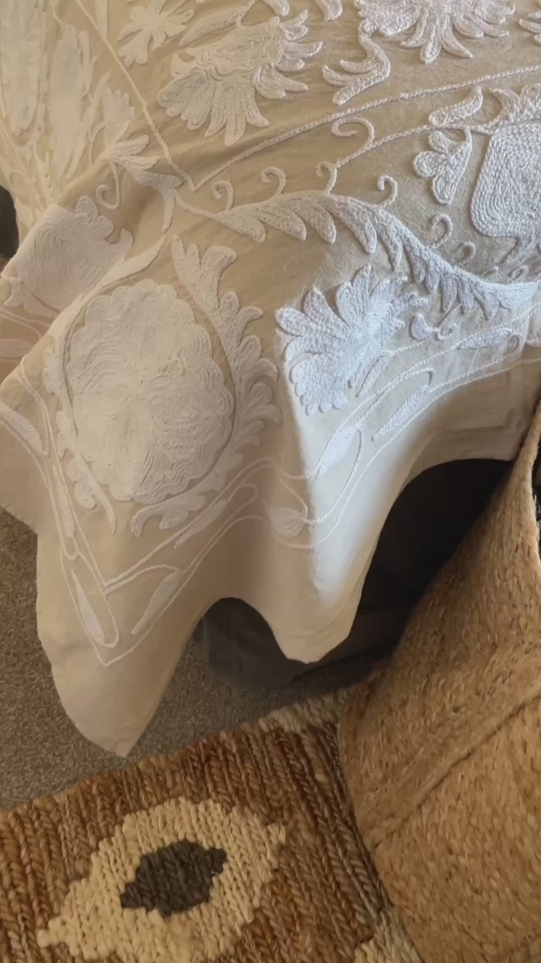 A beautifully hand stitched Suzani quilt in soft ecru and white, crafted on an off white linen base with intricate white embroidery. Designed to be styled as a king size bedspread or used as a statement sofa throw, this timeless piece brings texture, warmth and artisanal craftsmanship to any interior. Perfect for neutral bedrooms, relaxed living spaces and layered, collected homes