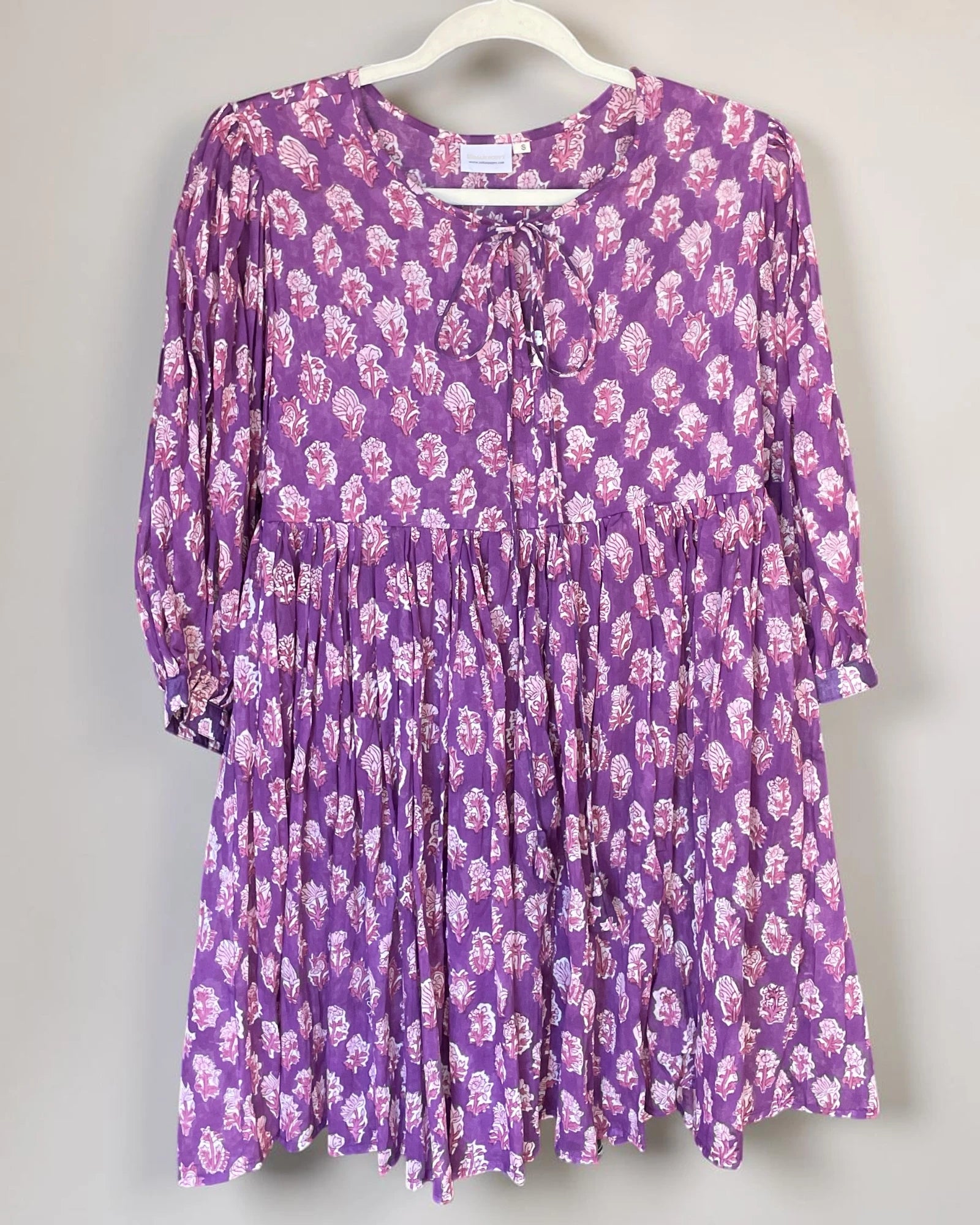 Purple hand block print cotton mini dress by Indian Poppy hanging to show its relaxed silhouette