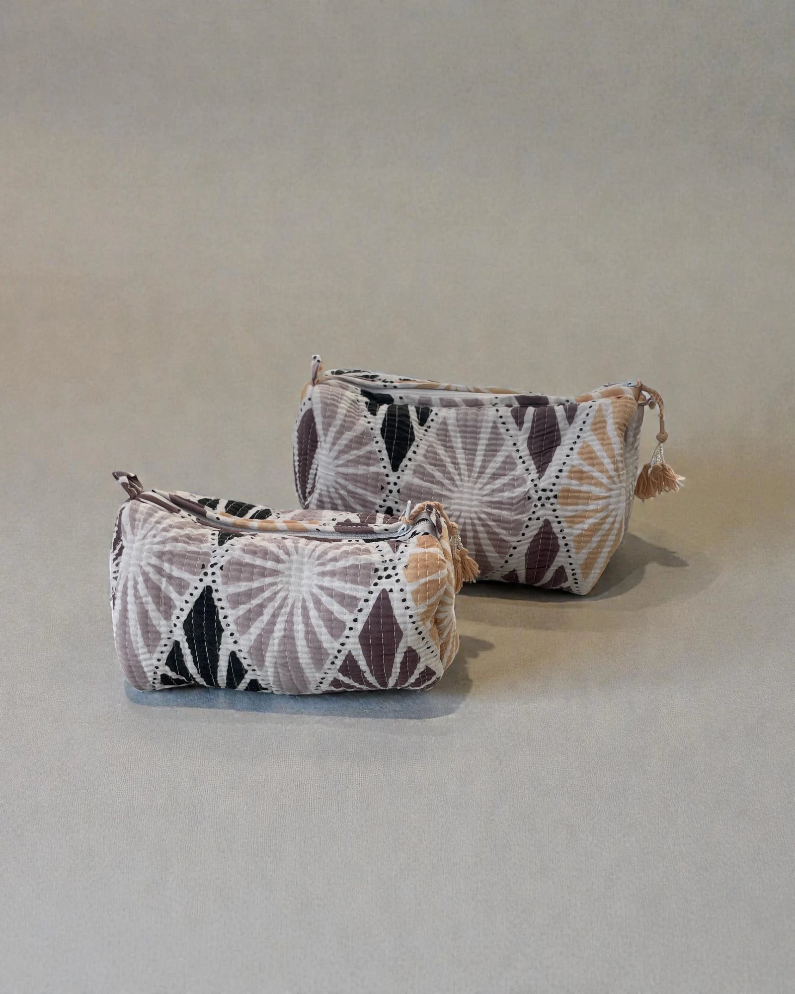 quilted cotton toiletry bag in soft pink and neutral tones with shell-style pattern