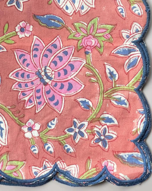 Handmade cotton napkins with a muted red base and navy blue scalloped edging for elegant table settings