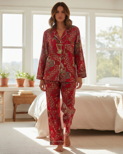 Model wearing scarlet red floral cotton pyjamas indoors showing relaxed fit and long sleeves