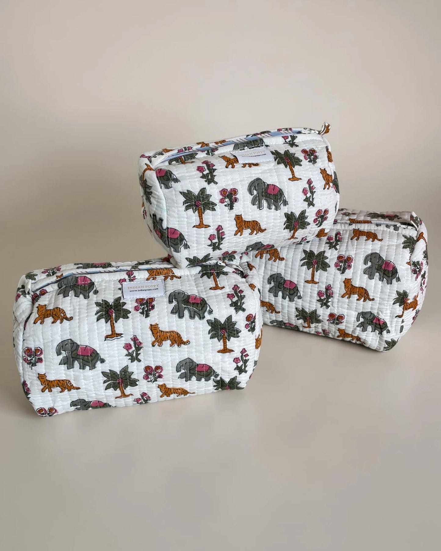 Set of three quilted wash bags in matching design, soft fabric cosmetic and toiletry pouches for travel and everyday organization
