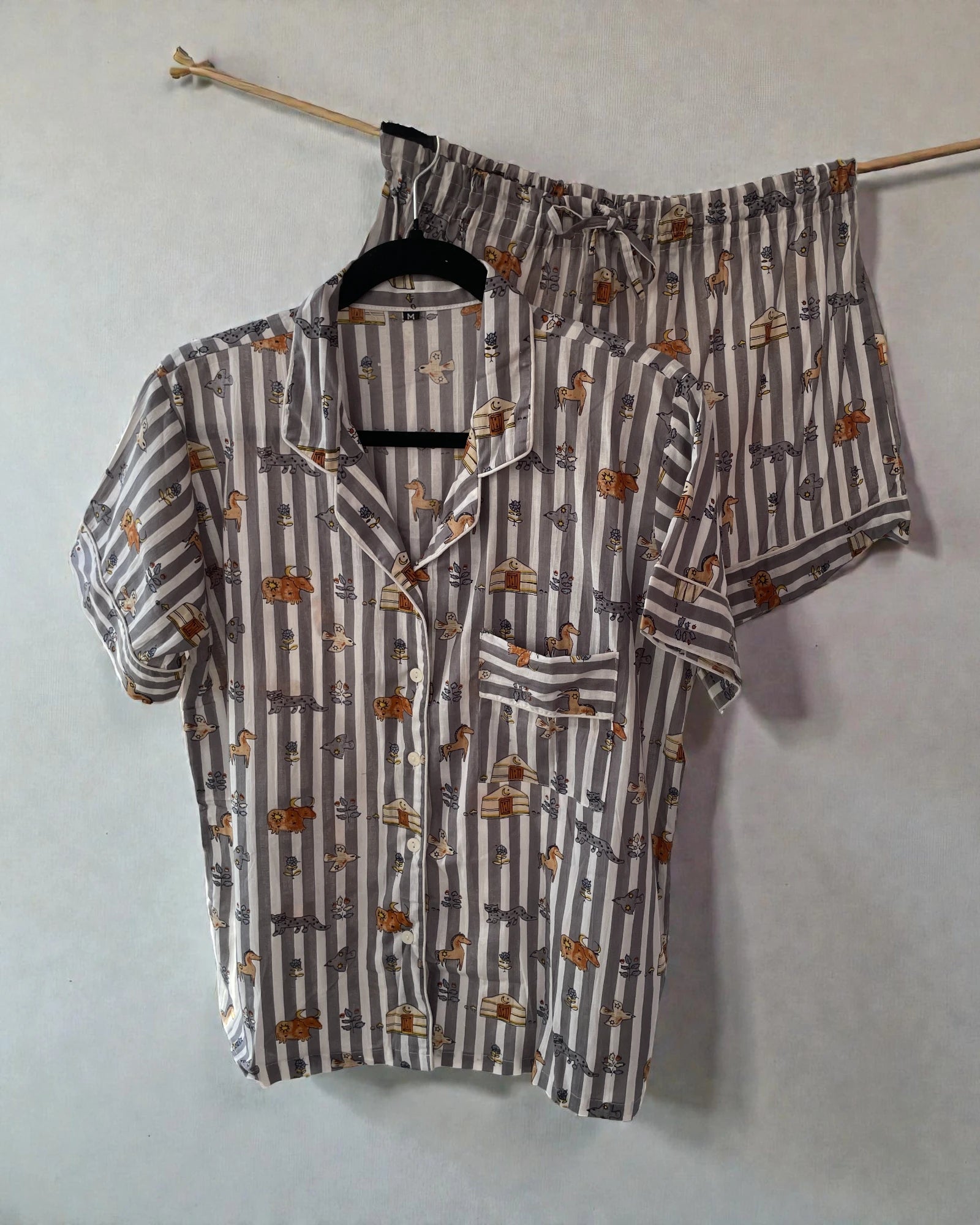 Women’s medium grey striped pyjamas with animal print, presented with matching gift bag