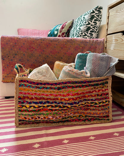 Side view of extra large storage basket in bright colourful rainbow threads with natural jute