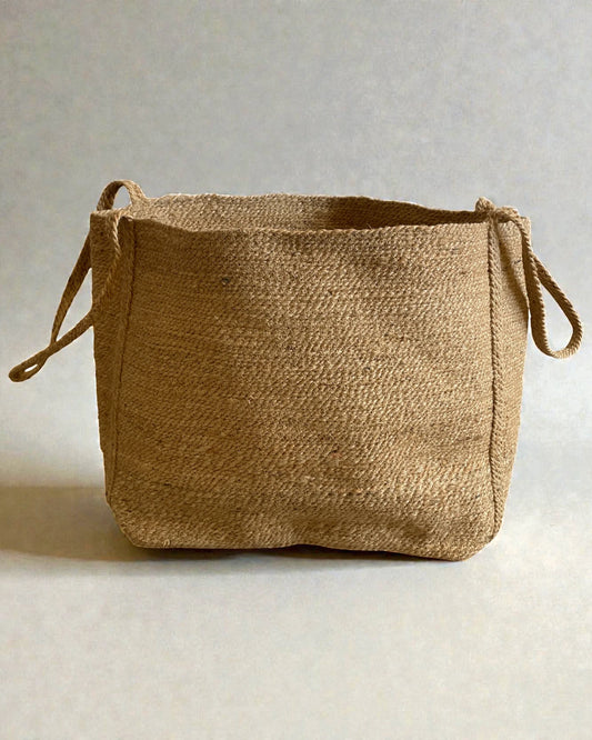 Natural sisal basket with woven handles designed for practical blanket storage