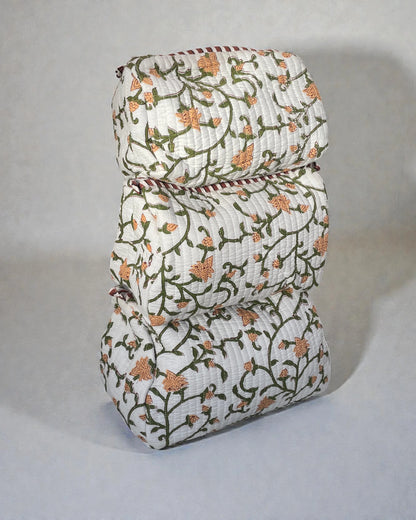 Three sizes of quilted cotton cosmetic bags in coordinating green floral fabric, designed for organised travel and storage.
