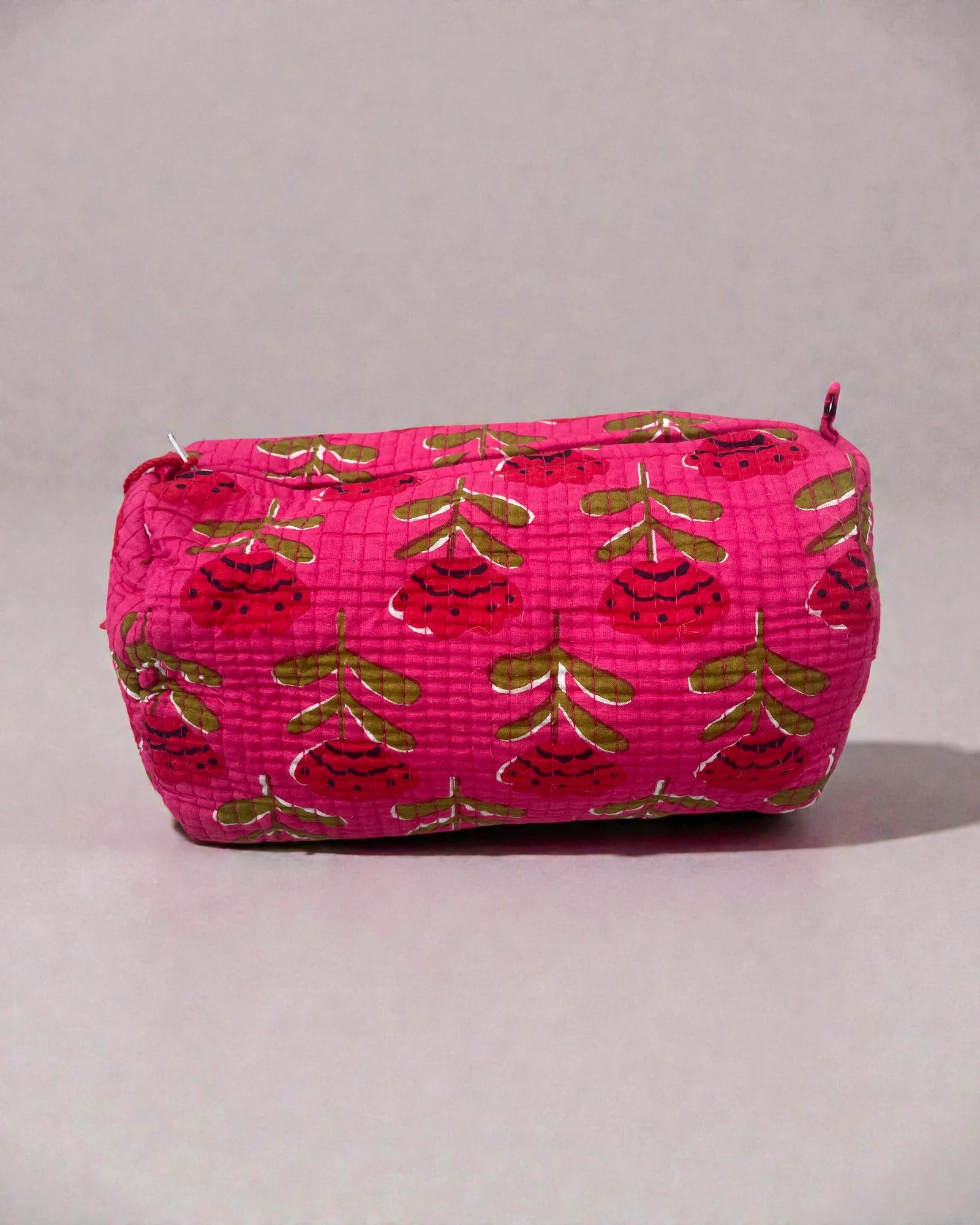 three-piece pink quilted toiletry bag set featuring floral pattern and beaded tassel zips
