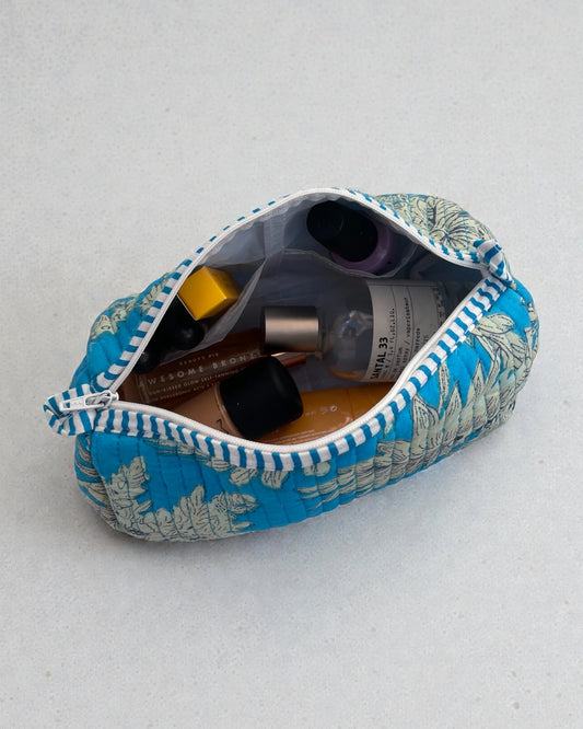 Teal blue floral makeup bags made from quilted cotton with waterproof lining