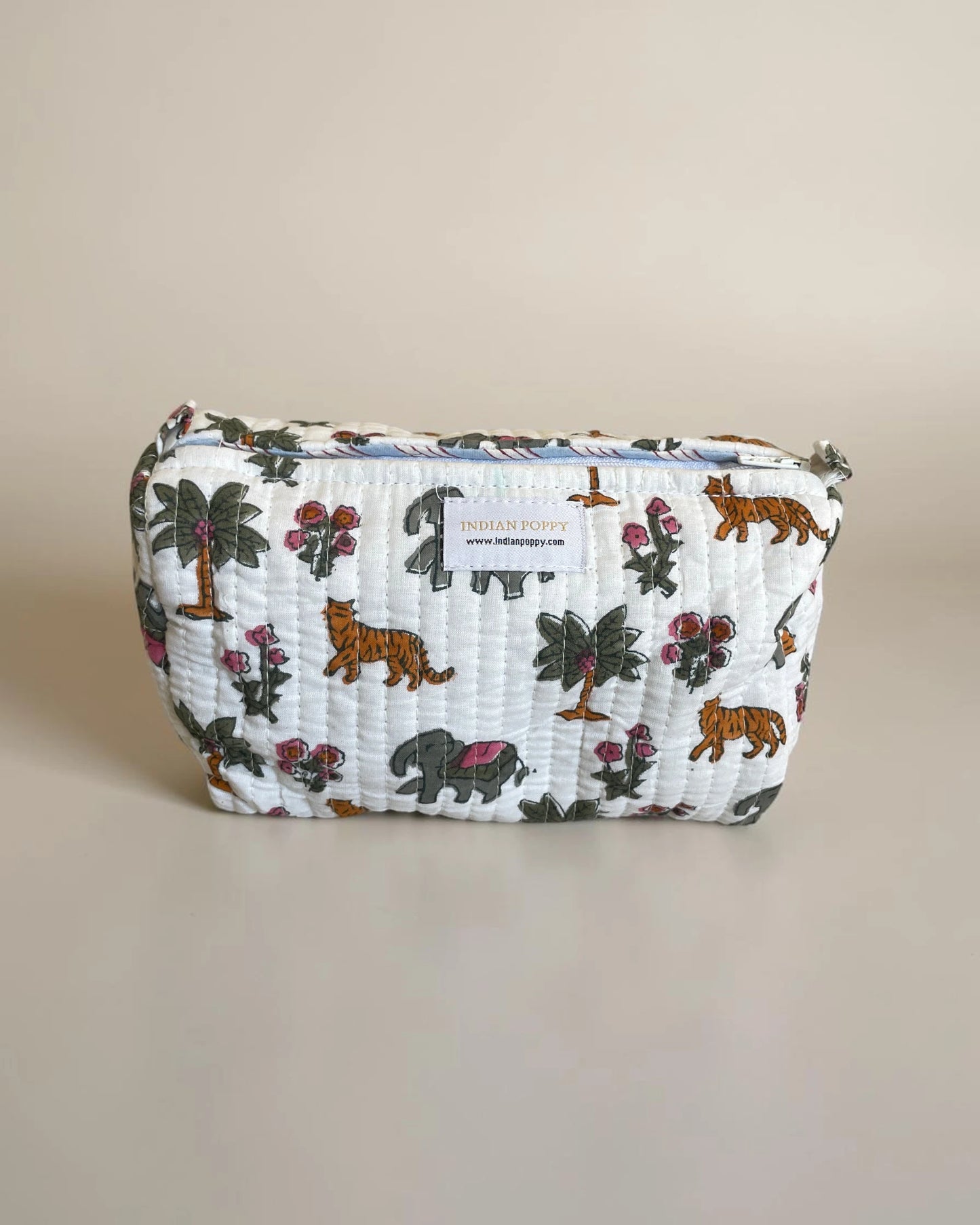 wash bag front view featuring elephant, tigers and palms all hand block printed