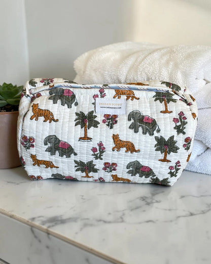 Fun, bright printed wash, toiletry and cosmetics bag displayed on a marble vanity, stylish giftable pouch for beauty essentials and travel accessories